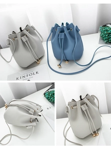 Detail of lychee pattern bucket bag featuring drawstring closure and gold metal accents
