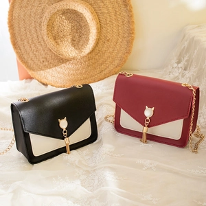 Elegant cat-themed crossbody chain bags in black and burgundy with tassel hardware