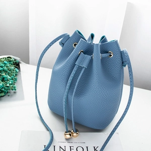 Light blue faux leather bucket bag with drawstring and gold metal sphere charms