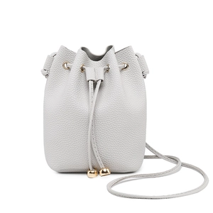 Light gray drawstring bucket bag with litchi texture and gold metal accents