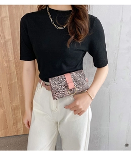 Detail of pink zebra print waist bag with gold circular buckle and leather belt
