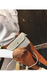 Light gray faux leather crossbody bag featuring lychee texture and round metal buckle