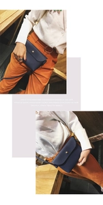Detail of navy blue pebble leather mini bag featuring elegant gold circular metal buckle