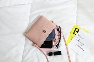 Internal view of pink pebble leather mini crossbody bag showing phone and wallet space