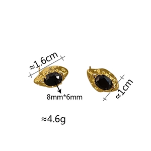 Detailed view of vintage gold earrings featuring black oval zircon with textured surface