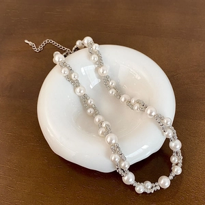 Close-up of double-layer pearl necklace with lobster clasp and adjustable metal chain