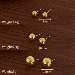 Detailed view of three pairs of polished gold ball stud earrings in 8mm, 10mm, and 14mm sizes