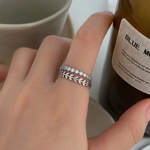 Silver leaf zircon stackable ring set worn by model in a minimalist lifestyle setting