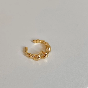 Macro view of the golden twisted croissant style ring with high polish metallic texture