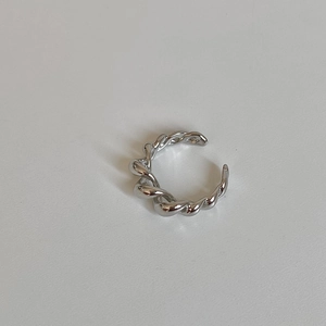Macro shot of silver twisted rope open ring featuring a polished braided metal design
