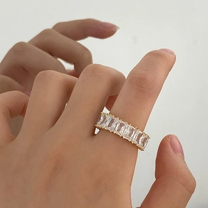 Elegant gold open ring with rectangle cubic zirconia stones on female model hand