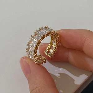 Macro shot of gold plated adjustable ring with square zircon baguette stones