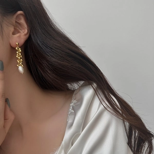 Elegant gold-plated tassel earrings featuring multiple beads and a drop-shaped pearl detail