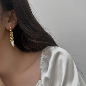 Elegant gold bead cluster and freshwater pearl tassel drop earrings on model