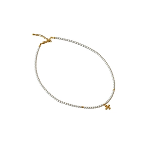 Elegant pearl necklace with gold beads and cross floral pendant on white background