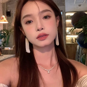 Elegant galaxy waterfall tassel earrings and pearl necklace set on a female model