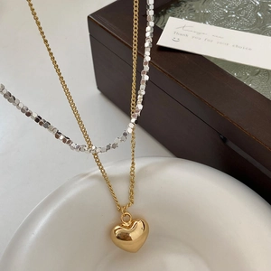 Double-layer necklace with golden heart pendant and silver cube bead chain design