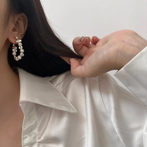 Vintage irregular silver beads and pearl tassel earrings shown on a model portrait