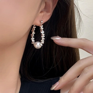 Elegant drop earrings featuring a large white pearl and polished silver-tone cube beads