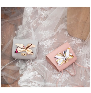 Litchi pattern crossbody bags in grey and pink with decorative floral silk scarves