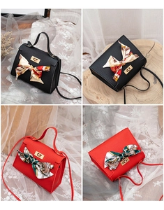 Close-up of mini lychee texture handbags with silk scarves and gold metal turn-lock closure