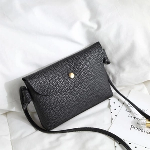 Black minimalist lychee grain faux leather crossbody bag with golden round buckle closure