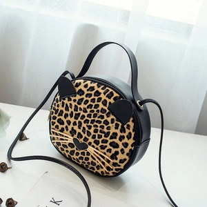 Fashionable black leather cat-shaped handbag with leopard print and gold cat whisker detail