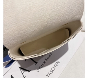 Close-up of the plush felt interior and metal magnetic closure of the leopard belt bag