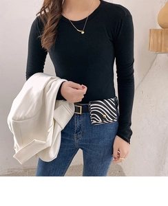 Detail of zebra print mini waist bag with gold buckle on blue jeans and black top