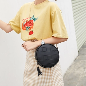 Casual black quilted round crossbody bag with tassel detail and gold chain strap
