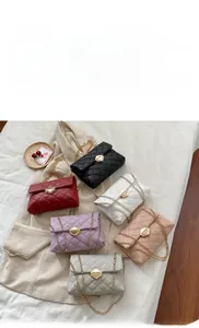 Close-up of quilted pattern and metal turn-lock on colorful chain shoulder bags