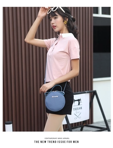 Blue circular leather crossbody bag styled with casual summer outfit in outdoor setting