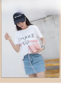 Pink minimalist crossbody bag with magnetic buckle and adjustable shoulder strap shown on model