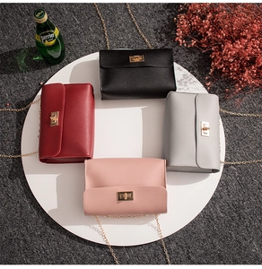 Detail view of four fashion chain flap bags in black, burgundy, pink and grey colors