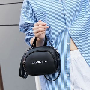 Fashionable black faux leather crossbody bag with white letter print and top handle