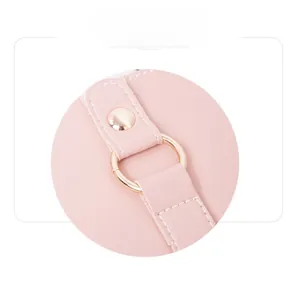Close-up of pink leather handbag showing fine texture and light gold metal hardware