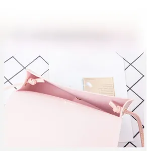 Detail view of pink PU leather small square bag interior with single layer compartment
