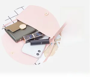 Interior view of pink laser crossbody bag showing capacity for phone and cosmetics