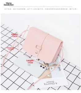 Pink crossbody bag dimensions 17x13x4.5cm shown next to phone on checkered fabric
