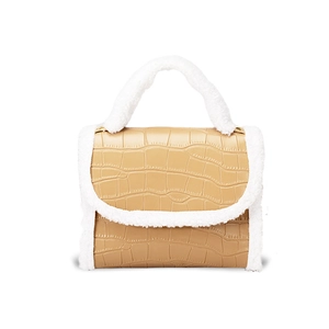 Women's brown faux crocodile handbag with white plush trim and elegant top handle design