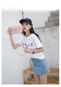 Detailed view of small pink crossbody bag with metal ring buckle and leather strap