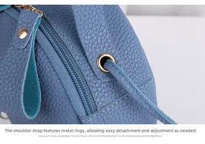 Macro shot of gold-plated metal buckles and textured leather on a lilac round handbag