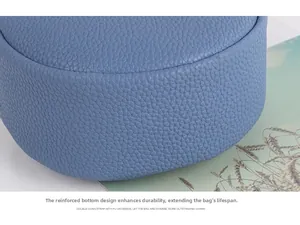 Detail shot of sky blue pebble leather bag with thickened wear-resistant bottom stitching