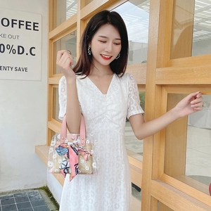 Transparent daisy print PVC bucket bag with woven lining and pink leather handles