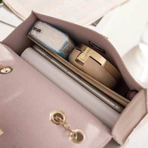 Fashionable pink chain crossbody bag interior showing spacious storage for daily essentials