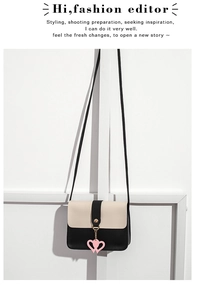 Detail of a contrast color square crossbody bag with pink heart pendant decoration