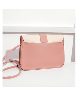 Detail of pink and beige crossbody bag with adjustable strap and decorative buckle