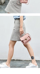 Pink faux leather shoulder bag with gold metal clasp worn by a model in the street