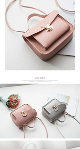 Close-up of elegant mini square crossbody bags with circular gold rotating locks