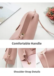 Close-up of soft pink leather bag showing wide handle, strap buckle and stitching details